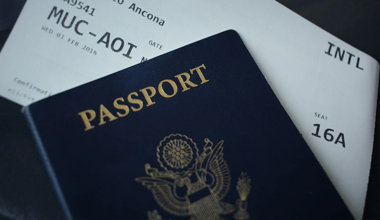 A passport and boarding documents on a table