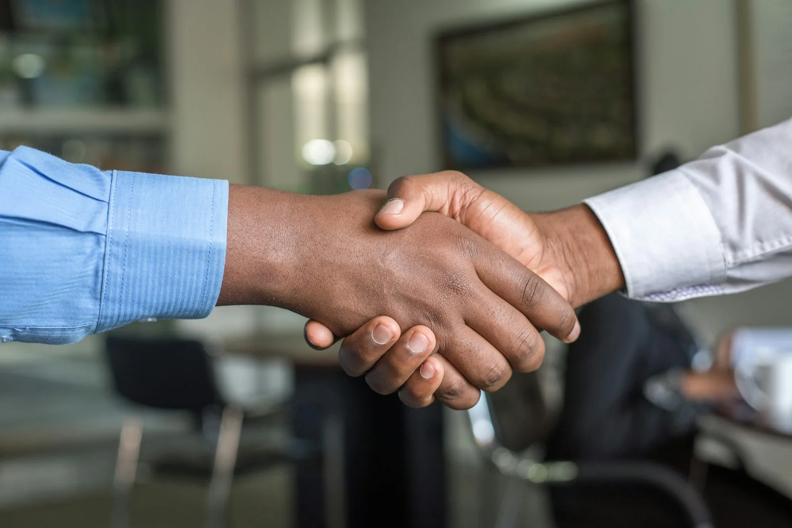 A close view of two people shaking hands in an office